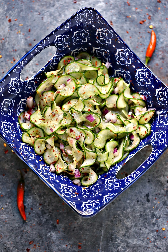 overhead image of Thai cucumber salad in a blue bowl