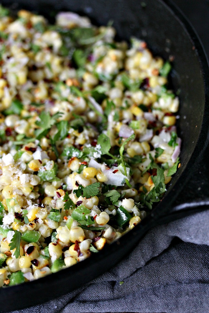 close up image of Mexican Street Corn Salad in a black cast iron skillet