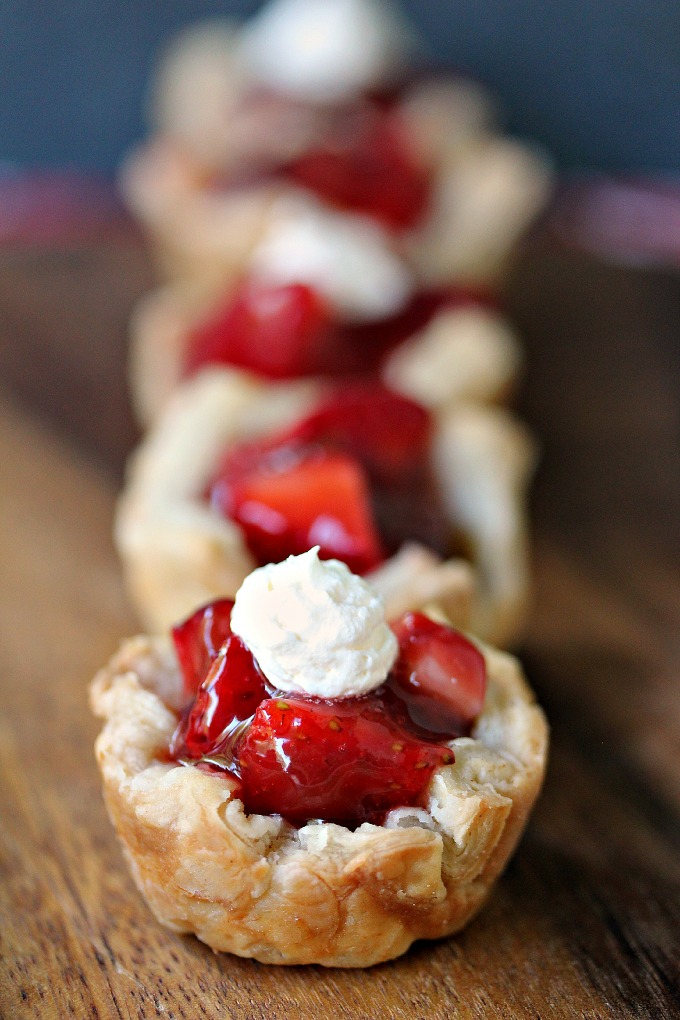 3 Strawberry Filled Mini Puff Pastries on wood surface