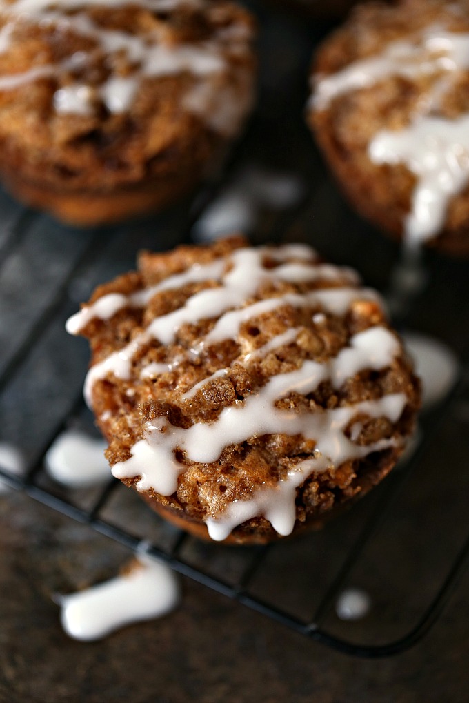 Cookie Butter Apple Cinnamon Muffins covered with Streusel Topping in a muffin tin 