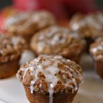 Cookie Butter Apple Cinnamon Muffins with Streusel Topping on a white cake stand