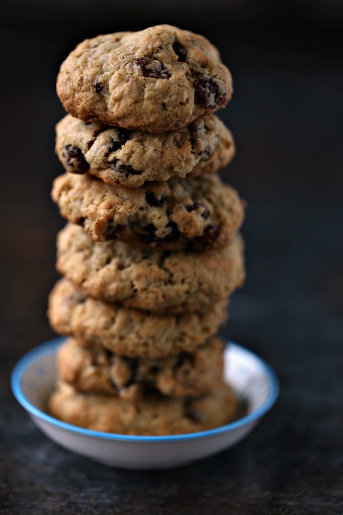 Oatmeal Raisin Cookies stacked on a tiny white and blue plate. 