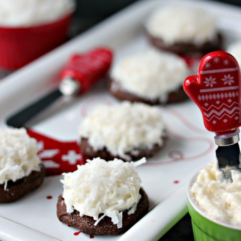 Chocolate coconut cookies on a white festive holiday platter.