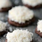 Chocolate coconut cookies on a grey marble counter.