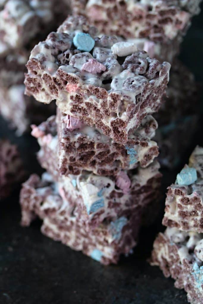 Stacks of Boo Berry Krispies on a dark counter.
