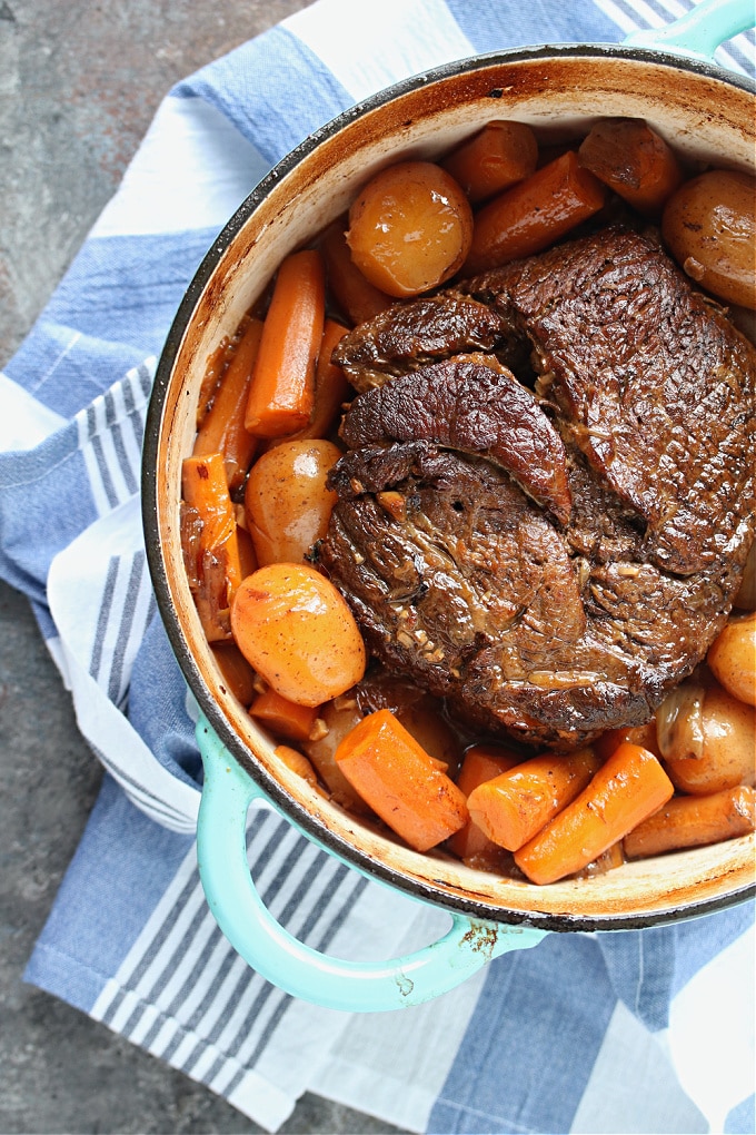 Overhead image of pot roast and veggies cooked in a dutch oven.
